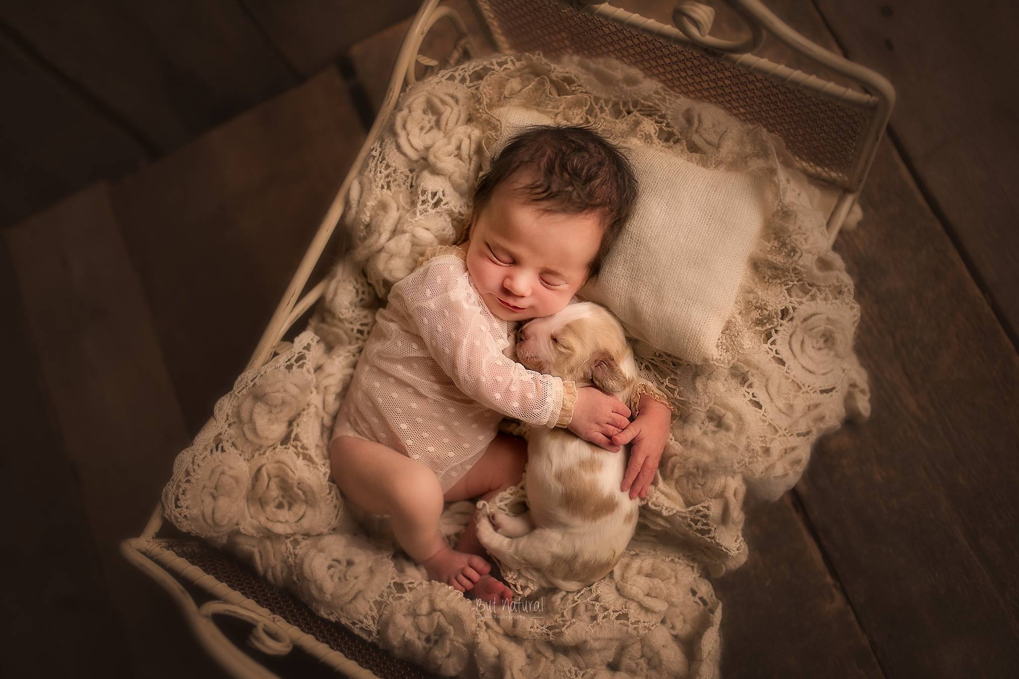 a baby sleeping with a puppy