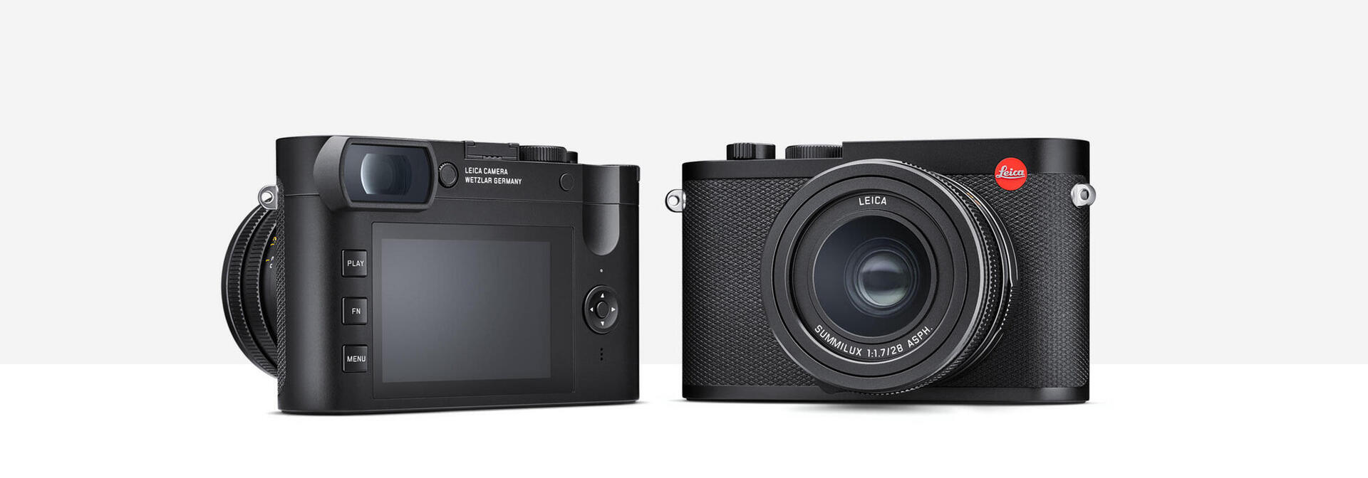 Leica Q2 : test et avis pour la photo de concert Leica Q2 de face, objectif Summilux 28mm lumineux, sur fond de scène de concert